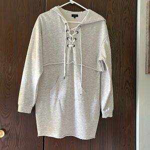 On twelfth gray lace up front hooded sweatshirt. Size Medium.